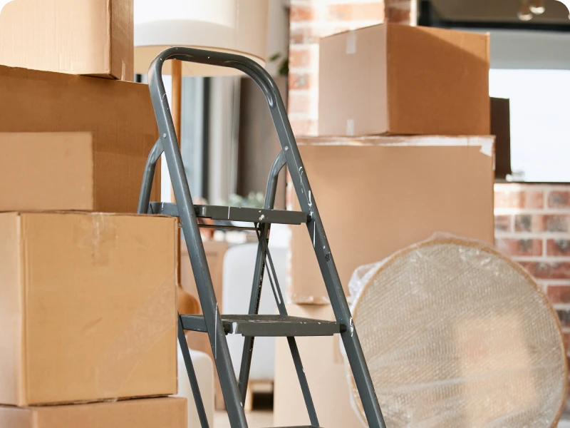 Stacked moving boxes and a ladder